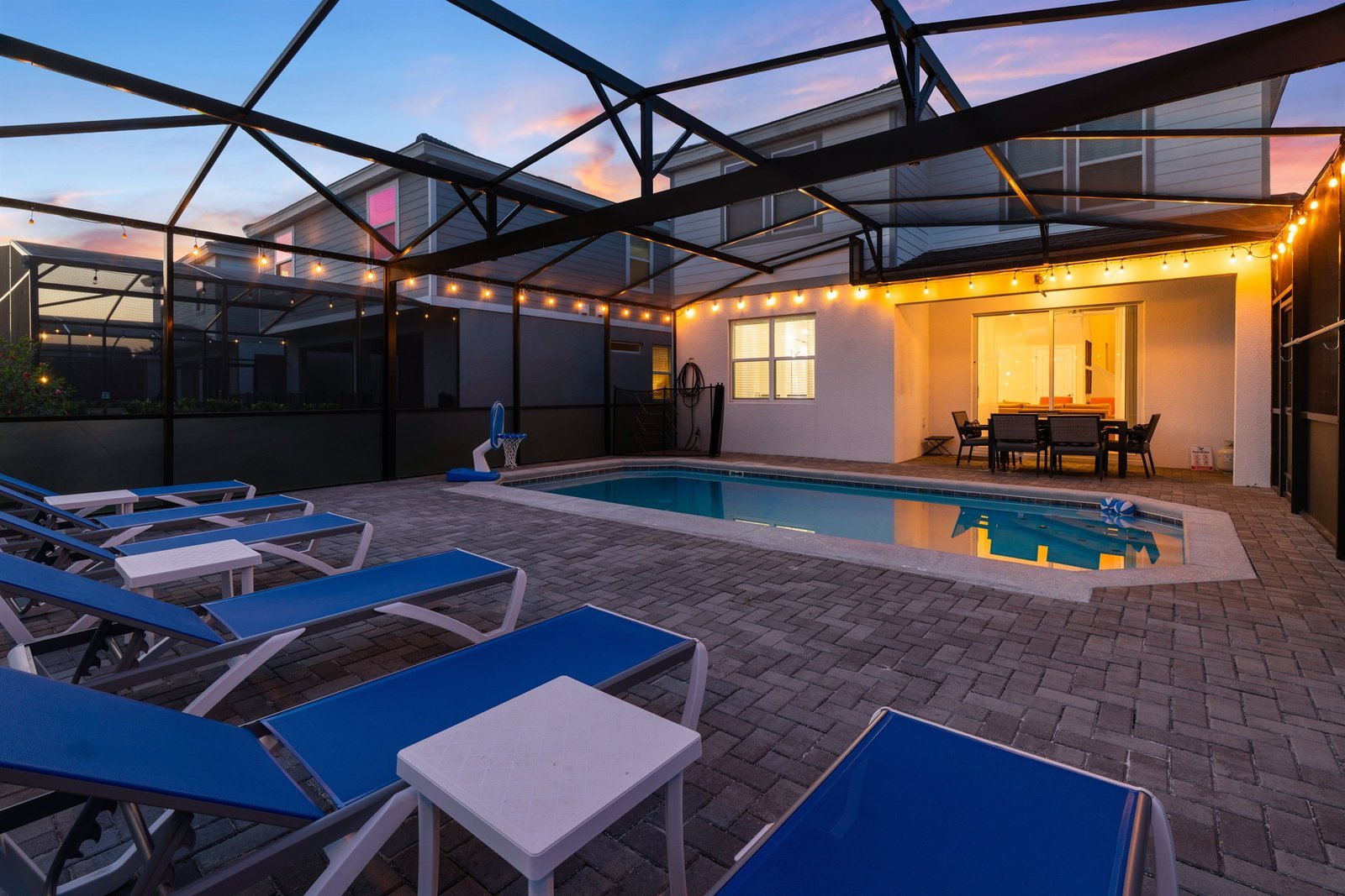 Poolside loungers and outdoor dining at sunset