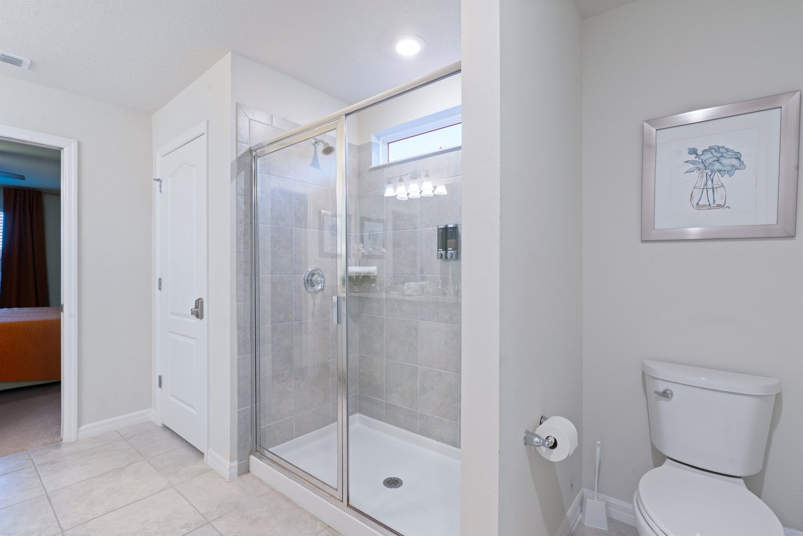 Bathroom with dispensers, hairdryers, and bright lighting