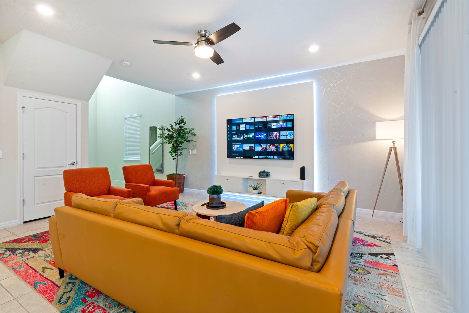 Bright spacious living room with large windows and plush seating